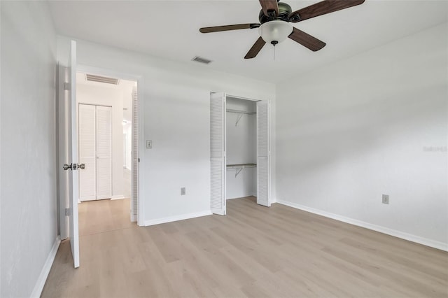 unfurnished bedroom with ceiling fan, a closet, and light hardwood / wood-style floors