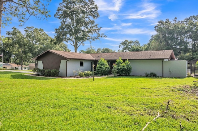 back of property featuring a yard