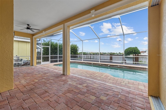 view of swimming pool featuring a patio area, a lanai, and ceiling fan