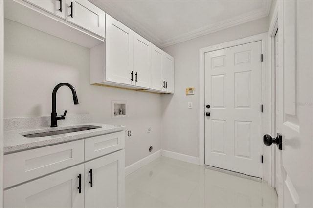 clothes washing area featuring washer hookup, cabinets, sink, and crown molding