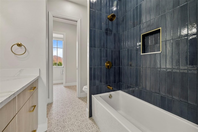 full bathroom with toilet, tiled shower / bath combo, and vanity