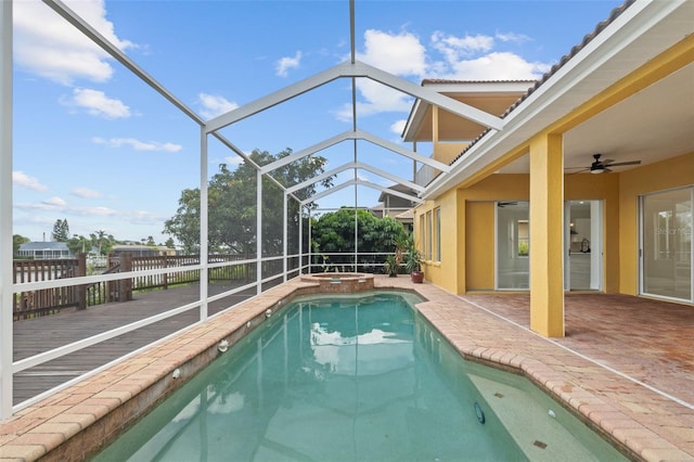 view of pool featuring ceiling fan, a lanai, and a patio area