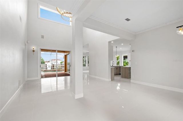 interior space featuring a healthy amount of sunlight, visible vents, a notable chandelier, and baseboards