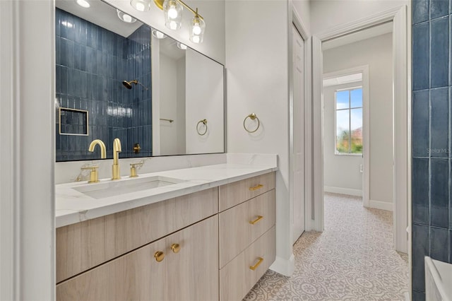 bathroom with tile patterned flooring, vanity, and baseboards