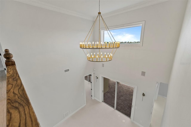 laundry room featuring a chandelier, baseboards, visible vents, and crown molding