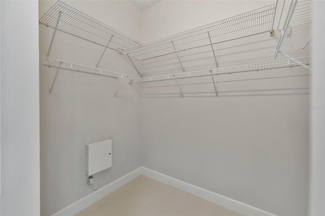 spacious closet with light tile patterned floors