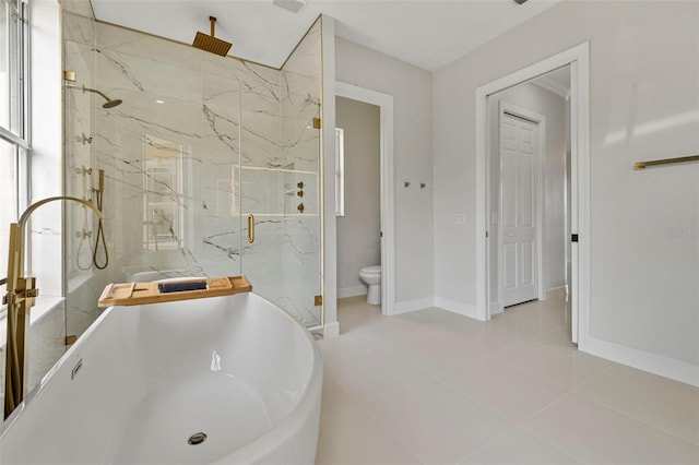 bathroom featuring a sink, a marble finish shower, toilet, tile patterned flooring, and baseboards
