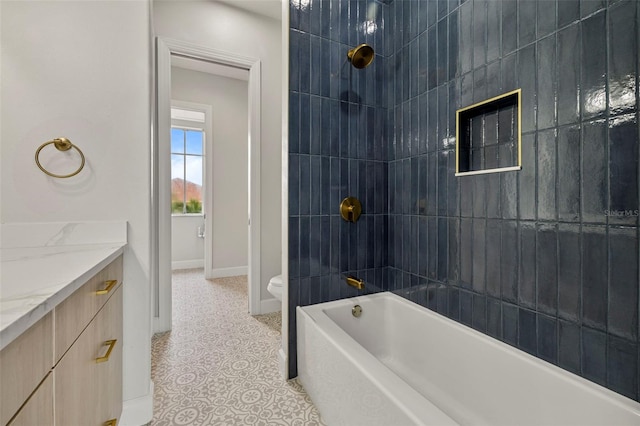 full bathroom featuring vanity, tile patterned flooring, baseboards, tub / shower combination, and toilet