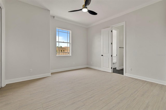 unfurnished room with ceiling fan, light wood-style floors, crown molding, and baseboards