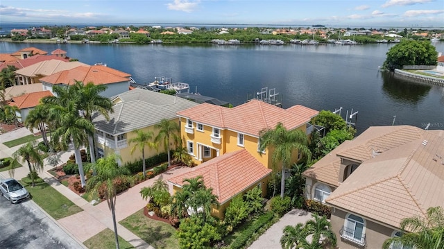 aerial view of residential area featuring a nearby body of water