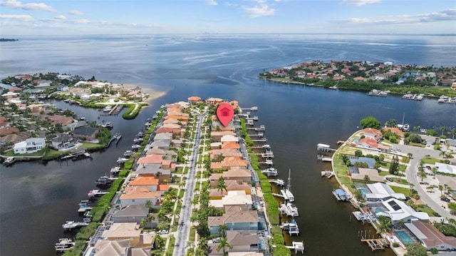aerial view of property and surrounding area with a nearby body of water and nearby suburban area