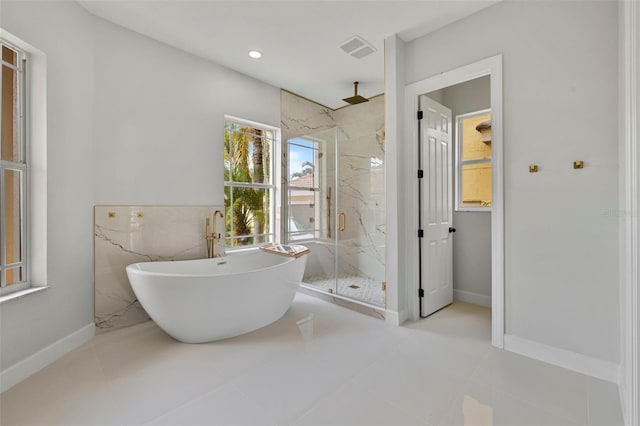 1233 Acappella Ln, Apollo Beach, FL 33572 - full bathroom with a marble finish shower, a freestanding bath, tile walls, and recessed lighting