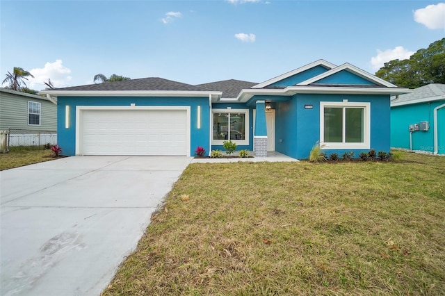 view of front of home with stucco siding, a front yard, fence, a garage, and driveway