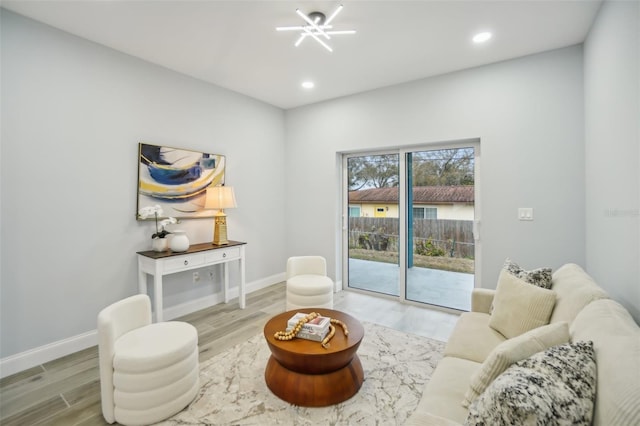 living area with recessed lighting, baseboards, and wood finished floors