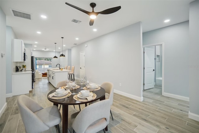 dining area with wood tiled floor, visible vents, and recessed lighting