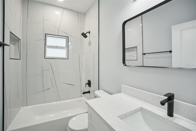 bathroom with tub / shower combination, vanity, and toilet