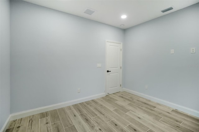 unfurnished room featuring baseboards, recessed lighting, visible vents, and light wood-style floors