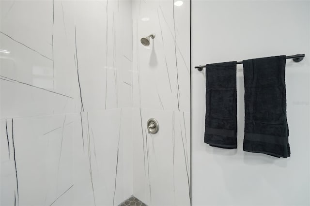 bathroom with a marble finish shower