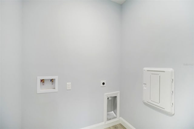 washroom with hookup for a washing machine, light wood-style floors, electric dryer hookup, laundry area, and baseboards