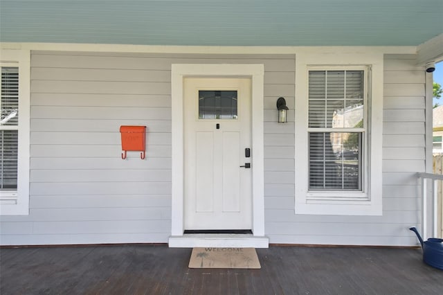 view of exterior entry featuring a porch