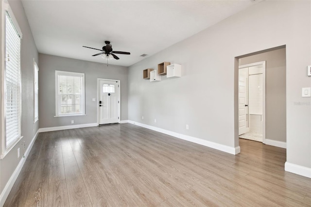 unfurnished living room with ceiling fan and light wood-type flooring