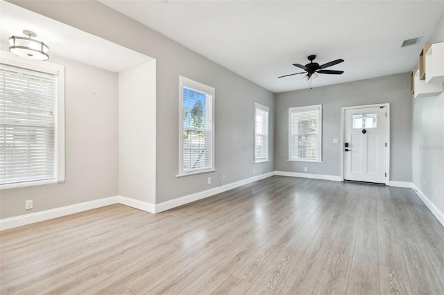 foyer entrance with ceiling fan and light hardwood / wood-style floors