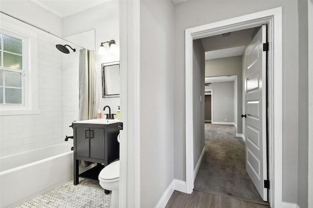 full bathroom featuring shower / tub combo with curtain, hardwood / wood-style floors, vanity, and toilet