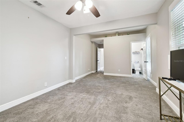 carpeted spare room with ceiling fan