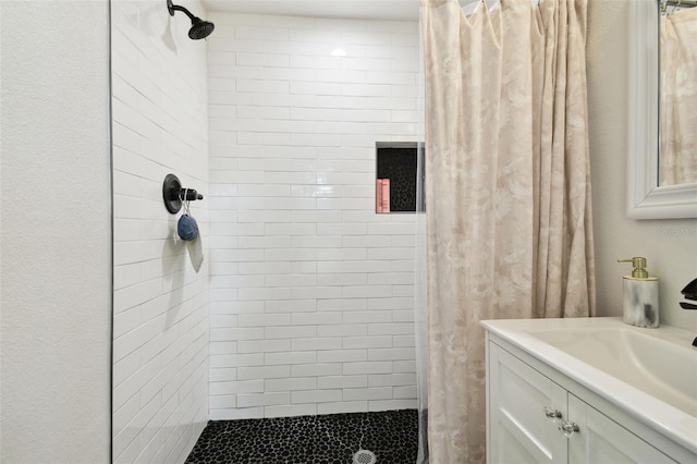 bathroom with walk in shower and vanity