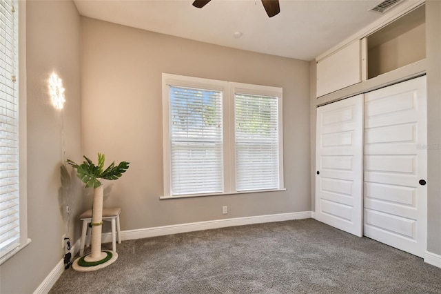 unfurnished bedroom with ceiling fan, a closet, and carpet