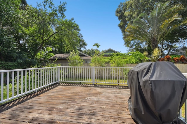 wooden deck featuring a grill