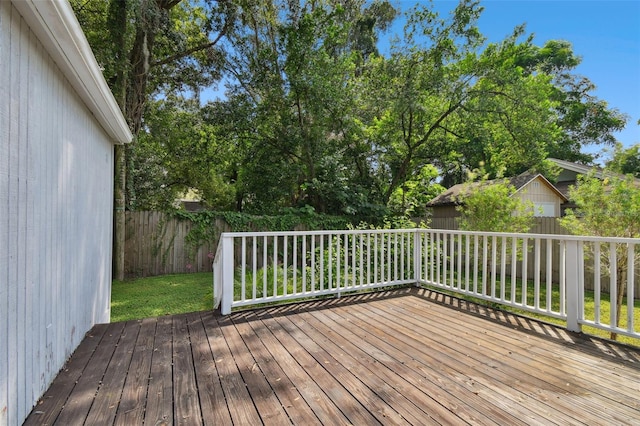 deck featuring a lawn and a shed