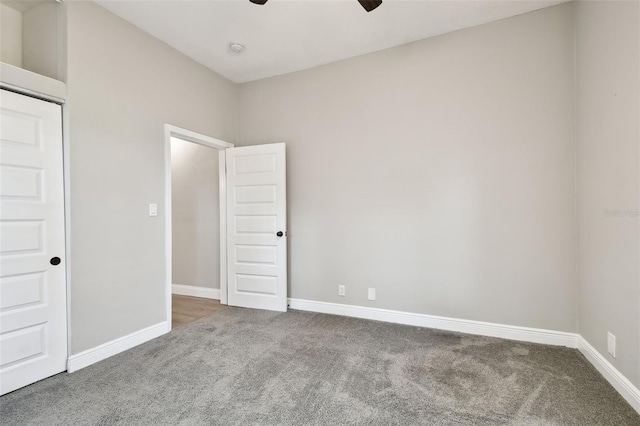 unfurnished room with carpet flooring, ceiling fan, and baseboards