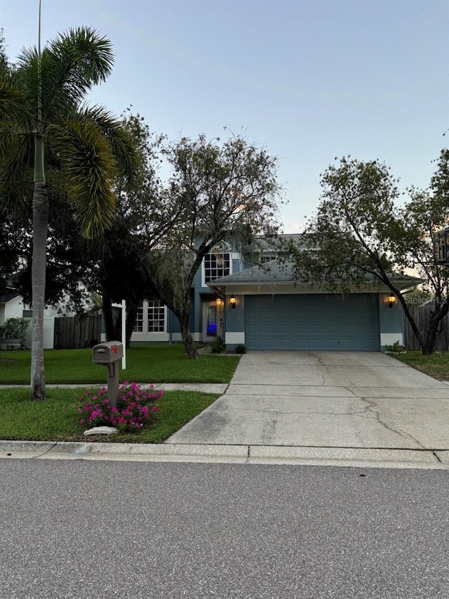 view of front of home featuring a lawn and a garage