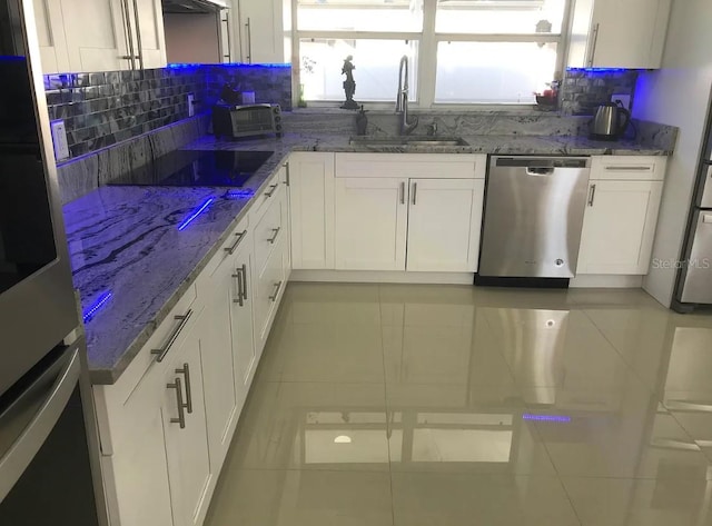 kitchen with white cabinetry, appliances with stainless steel finishes, and sink