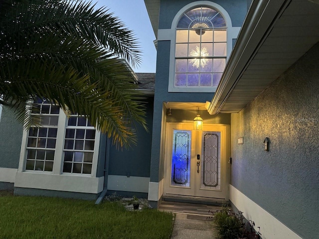 view of exterior entry at dusk