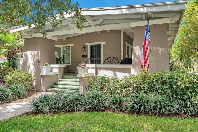 view of front of property featuring stucco siding and a porch