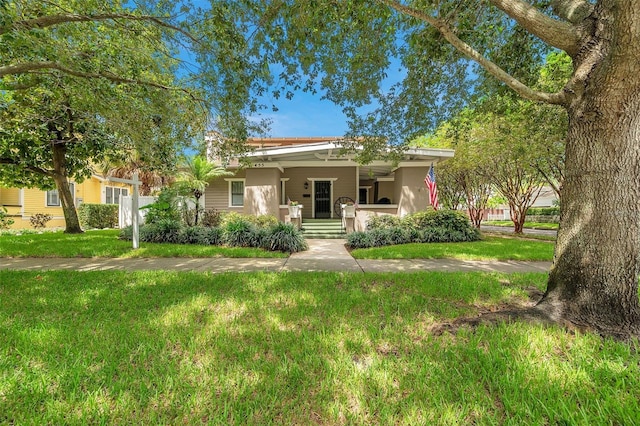 view of front of house with covered porch and a front yard