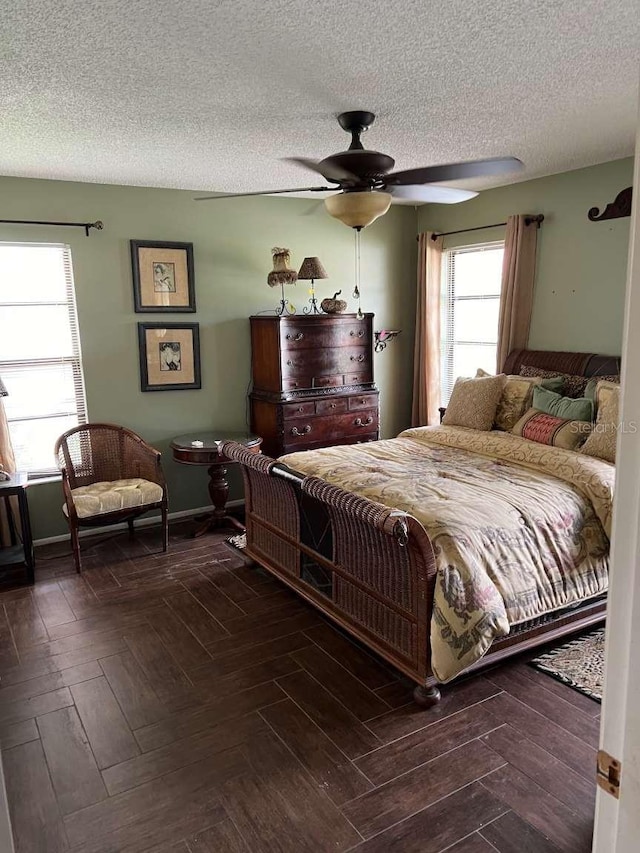 bedroom with a textured ceiling and ceiling fan