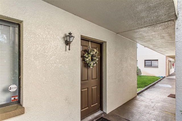 view of exterior entry featuring stucco siding