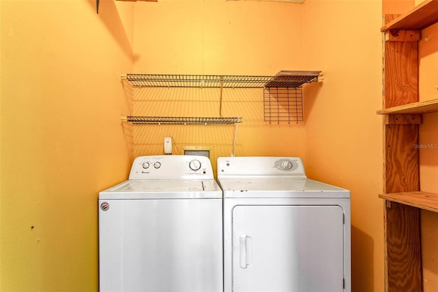 clothes washing area with laundry area and washer and clothes dryer