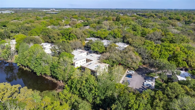 drone / aerial view featuring a view of trees and a water view