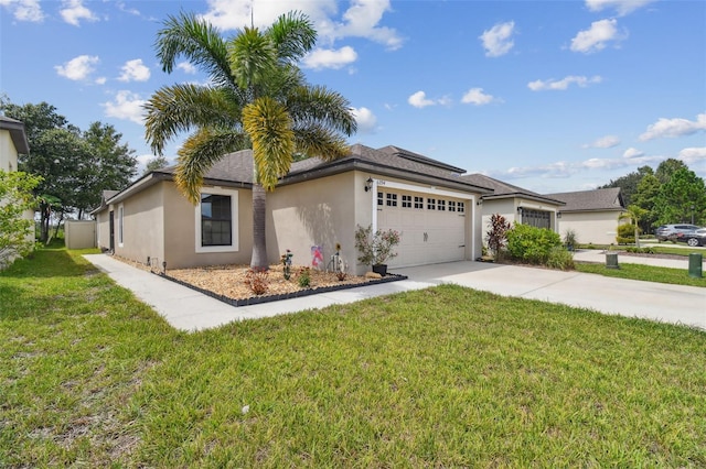 view of front of home with a front yard and a garage