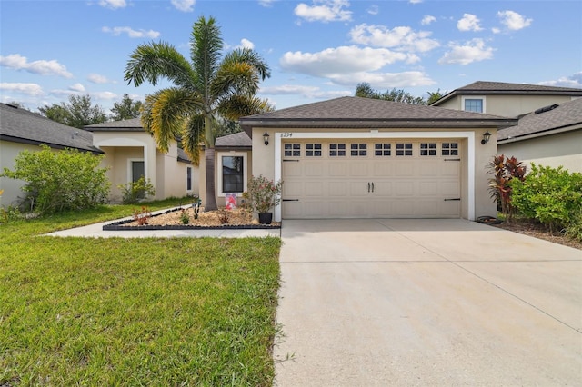 view of front of property featuring a front yard and a garage