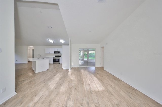 unfurnished living room featuring light wood-type flooring and sink