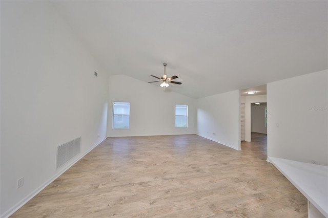 unfurnished living room with light hardwood / wood-style floors, vaulted ceiling, and ceiling fan