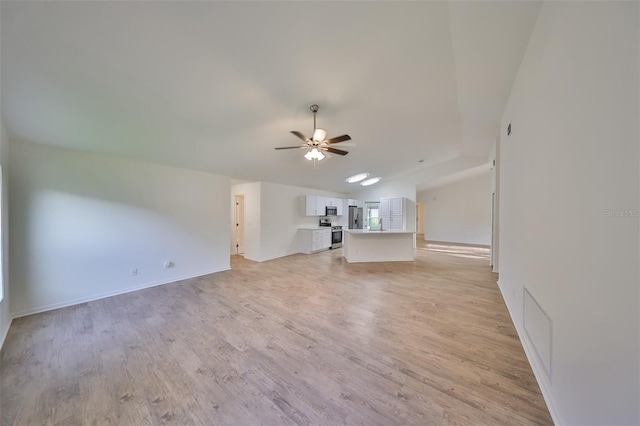 unfurnished living room with ceiling fan, light hardwood / wood-style floors, and lofted ceiling