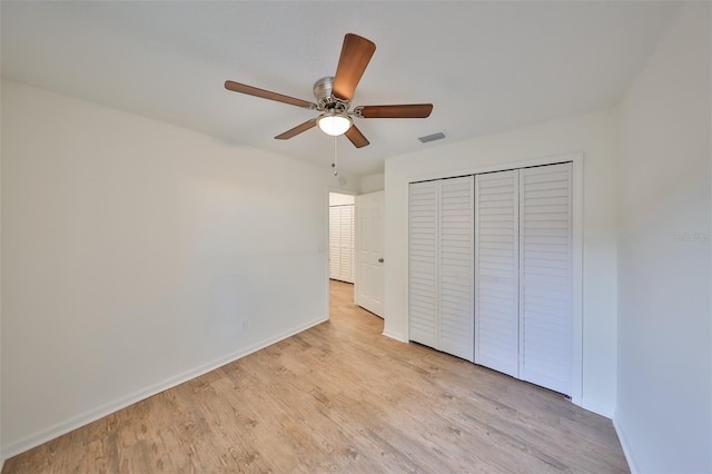 unfurnished bedroom with ceiling fan, a closet, and light hardwood / wood-style flooring