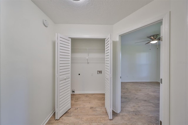 interior space featuring a textured ceiling and light wood-type flooring