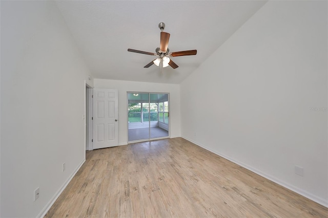 spare room with ceiling fan, lofted ceiling, and light wood-type flooring